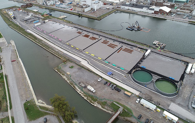 Aerial view of the Port Hope Harbour, a vast industrial area featuring factories, warehouses, and transportation networks.