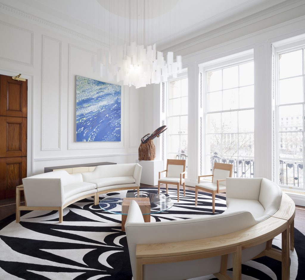 The British Columbia room featuring a custom-designed black and white rug and curved couches.