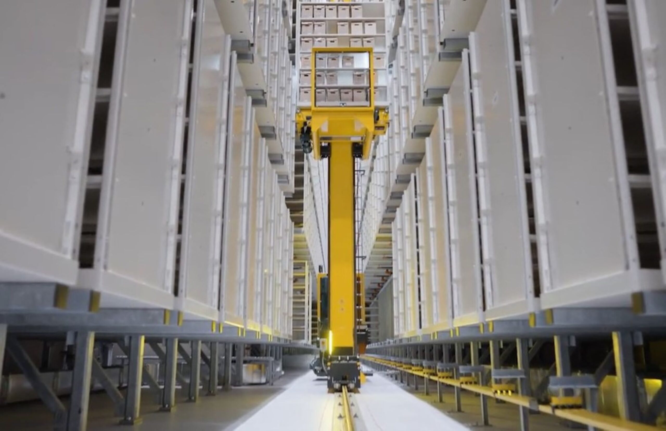 LAC's automated storage and retrieval system is seen moving through a vault, efficiently handling archival materials.