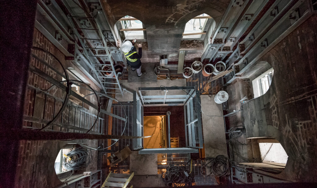 Interior view of Centre Block's ventilation tower under construction, featuring scaffolding and exposed structural elements.